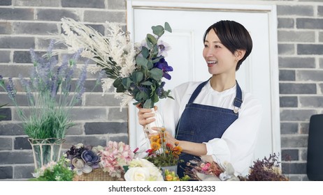 Asian Woman Working In Flower Shop. Flower Coordinator. Flower Arrangement.