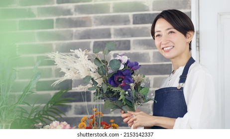 Asian Woman Working In Flower Shop. Flower Coordinator. Flower Arrangement.