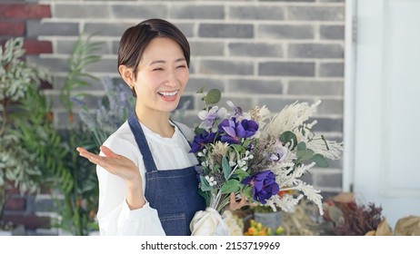 Asian Woman Working In Flower Shop. Flower Coordinator. Flower Arrangement.