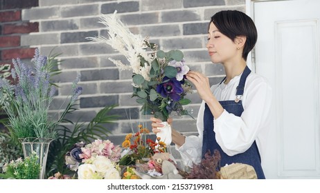 Asian Woman Working In Flower Shop. Flower Coordinator. Flower Arrangement.