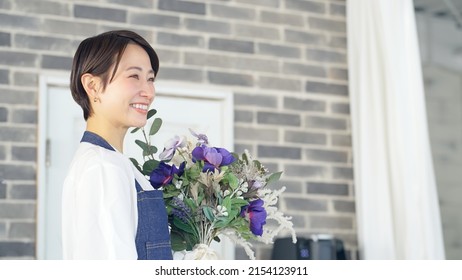 Asian Woman Working In Flower Shop. Flower Coordinator. Flower Arrangement.