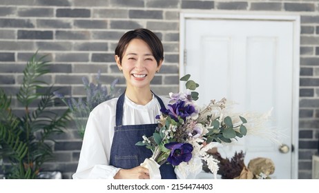 Asian Woman Working In Flower Shop. Flower Coordinator. Flower Arrangement.