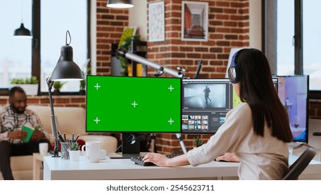 Asian woman working from home as a freelance video editor, using isolated mockup display and video mixing software. Creative workspace equipped with dual monitors and tech tools. Camera B. - Powered by Shutterstock