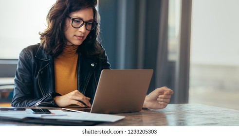 Asian woman working laptop. Business woman busy working on laptop computer at office. - Shutterstock ID 1233205303