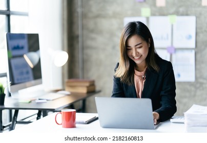 Asian Woman Working With Laptop In Her Office. Business Financial Concept.