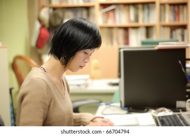 Asian Woman Working In Office With Lonely And Tired Expression.