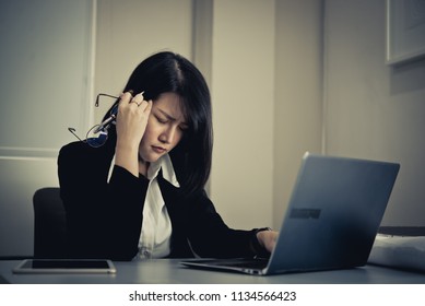 Asian woman working in office,young business woman stressed from work overload with a lot file on the desk,Thailand people thinking something - Shutterstock ID 1134566423