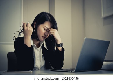 Asian woman working in office,young business woman stressed from work overload with a lot file on the desk,Thailand people thinking something - Shutterstock ID 1321830458