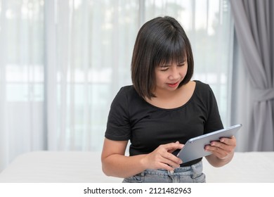 Asian Woman Working On Laptop At Room. Concept Of Work Form Home. Portrait Women Smile Use Technology Mobile. Concept Business.