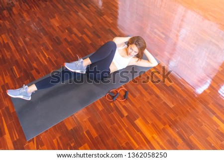 Similar – Image, Stock Photo Woman stretching on yoga mat in a yoga studio