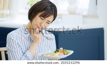 Asian woman worried about eating