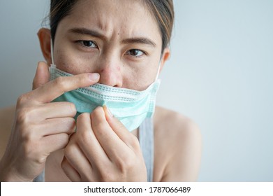 Asian Woman Worry About Acne Occur On Her Face After Wearing Mask For Long Time During Covid-19 Pandemic. Wearing Mask For Prolonged Periods Can Damage The Skin.