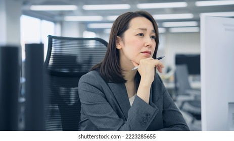 Asian woman worrying in office. - Shutterstock ID 2223285655