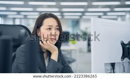 Asian woman worrying in office.