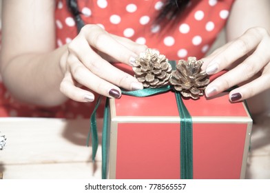 Asian Woman Wrapping Gift Box Red Ribbon Green.