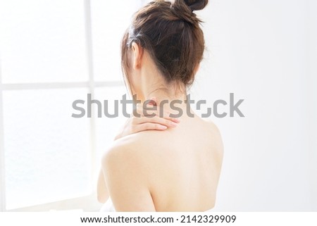 Asian woman's body care of her back