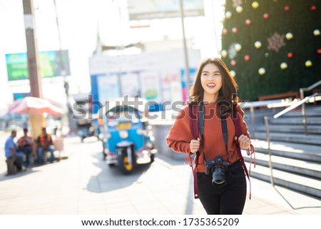 Asian women be smile with camera Travel Holiday Relaxation Concept in Bangkok Thailand.