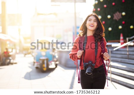 Asian women be smile with camera Travel Holiday Relaxation Concept in Bangkok Thailand.