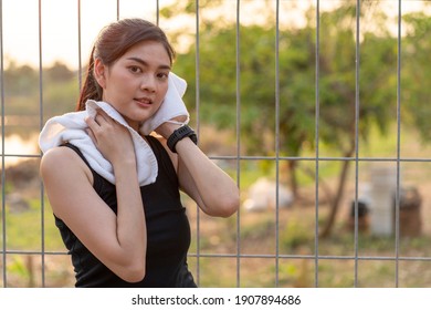 Asian Women, Beautiful Women, Jogging In The Evening, Running Tired, Using A Small Towel To Freshen Up The Dryness. Sport And Health Concept.