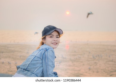Asian women being happy with beautiful sunset time  , Location of Bangpoo samutprakarn province , Thailand