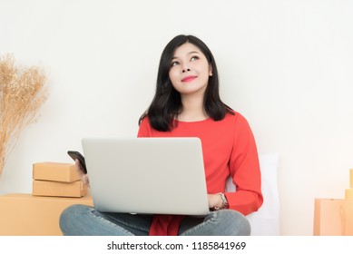 Asian women buying goods online through computer and cell phone. - Shutterstock ID 1185841969