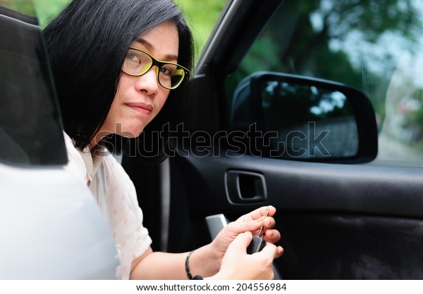 asian women in the car with\
key