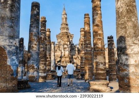 Asian women and Caucasian men visiting Wat Mahathat Sukhothai, an old city in Thailand. Ancient city and culture of South Asia Thailand, Sukhothai Historical Park
