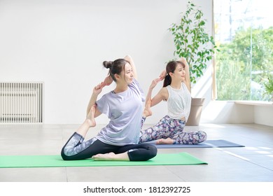 Asian women doing yoga indoor - Powered by Shutterstock