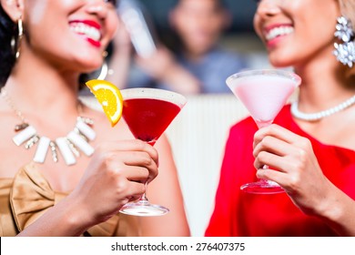 Asian Women Drinking Cocktails In Fancy Bar