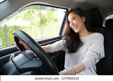 Asian women driving a car and smile happily with glad positive expression during the drive to travel journey, People enjoy laughing transport and relaxed happy woman on roadtrip vacation concept - Shutterstock ID 1279005610