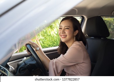 Asian women driving a car and smile happily with glad positive expression during the drive to travel journey, People enjoy laughing transport and relaxed happy woman on roadtrip vacation concept - Shutterstock ID 1377822857