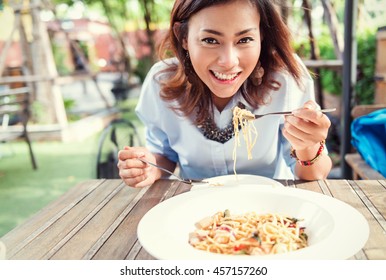 Asian Women Eating Delicious,Focus On Face