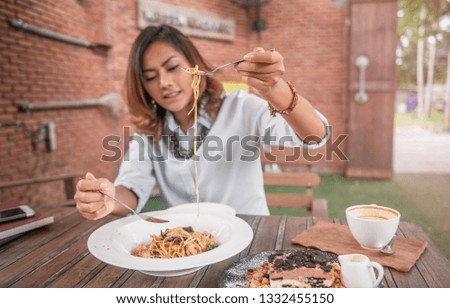 Asian women eating delicious,Focus on fork.