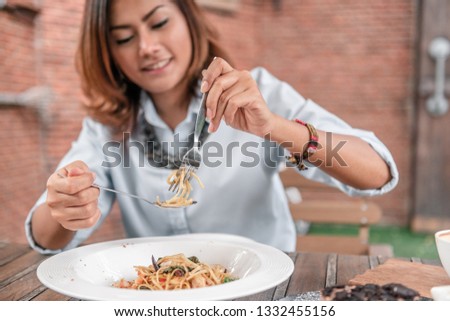 Asian women eating delicious,Focus on hand.
