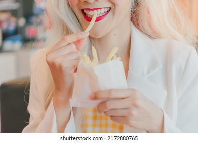 Asian Women Enjoy Eating With French Fries.