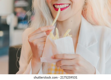 Asian Women Enjoy Eating With French Fries.