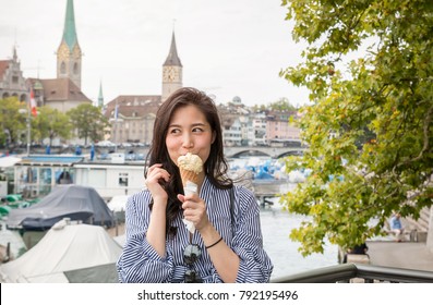 Asian Women Enjoying Ice Cream While Travelling In Europe. Having Ice-cream In Hot Summer Day. Chinese Asian Young Female Model Eating Ice Cream Cone When Travel In Europe. 