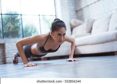 Asian women exercise indoor at home she is acted "push up" - Shutterstock ID 552856144