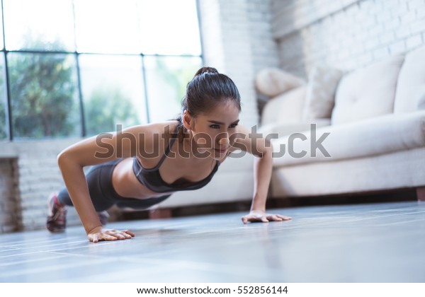 Asian women exercise indoor at home she is acted\
\