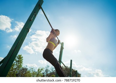 Asian Women Exercise In The Morning With Pull Up.