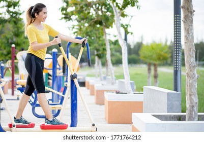 Asian Women Exercise At The Park, Use The Equipment To Exercise And Stay Fit, Healthy And In Good Shape.