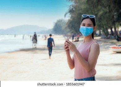 Asian women and face mask travel on beach at Phuket sea Thailand - Powered by Shutterstock