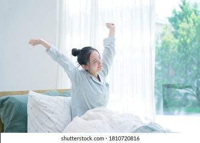 Asian women getting up at home