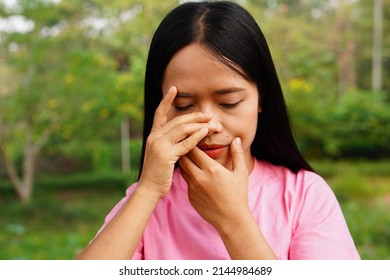 Asian Women Has An Itchy Nose.