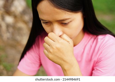 Asian Women Has An Itchy Nose.