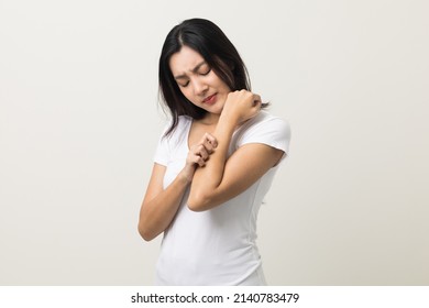 Asian women have skin problems She felt irritation on her skin. Skin infection itching red rash scratching with hands. She around 25 Wearing white shirt standing on isolate background - Shutterstock ID 2140783479
