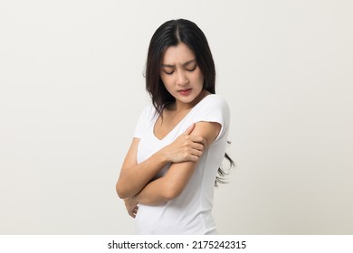 Asian women have skin problems She felt irritation on her skin. Skin infection itching red rash scratching with hands. She around 25 Wearing white shirt standing on isolate background - Shutterstock ID 2175242315
