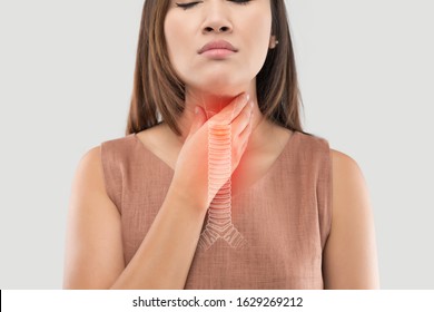 Asian women have symptoms of burning sensation on a gray background. Bronchitis and pneumonia of women