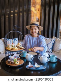 Asian Women Having A Luxury High Tea With Snacks And Tea In A Luxury Hotel