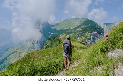 Asian women hiking in the Swiss Alps mountains during summer vacation with a backpack and hiking boots. woman walking on the Saxer Lucke path a popular hiking trail in Switzerland - Shutterstock ID 2279297571
